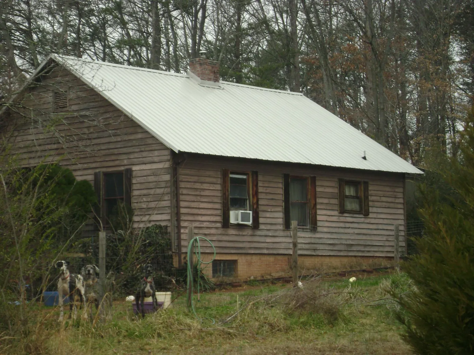 White metal roof on an old wood sided farmhouse, from a Metal Roof Installation job in Spiceland